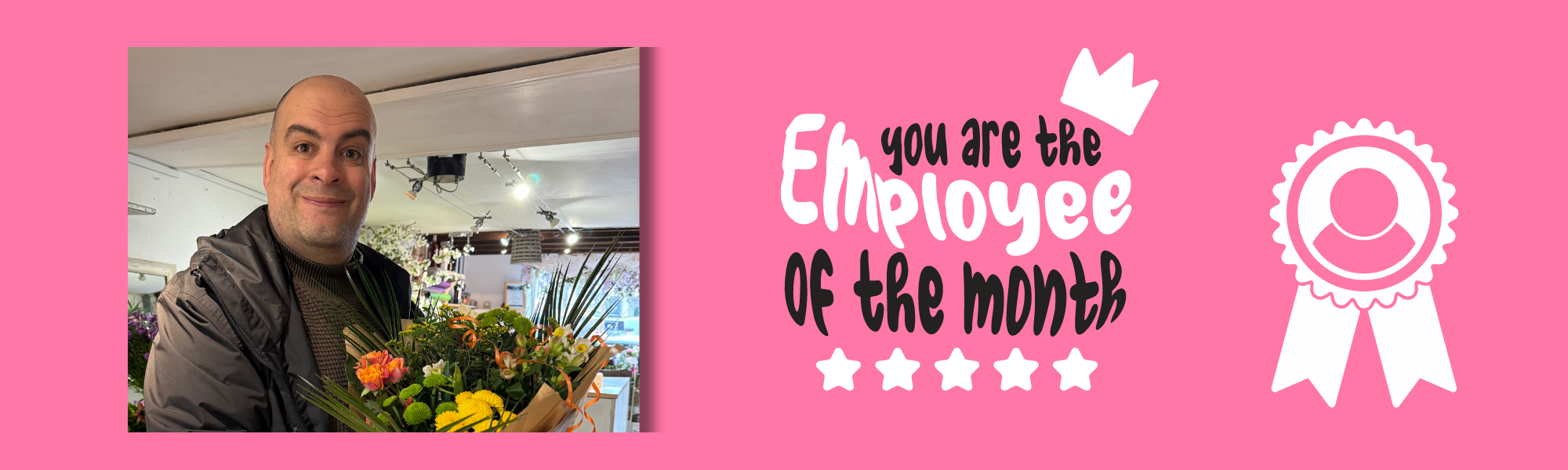 A pink banner with a  smiling man holding a bunch of flowers. the text reads Employee of the Month with a rosette graphic.