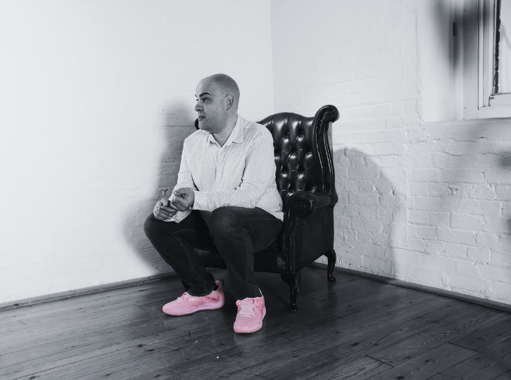Smiling man holds a large bunch of flowers