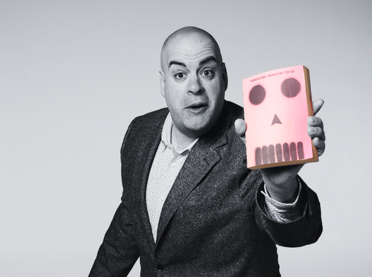 Smiling man holds a large bunch of flowers